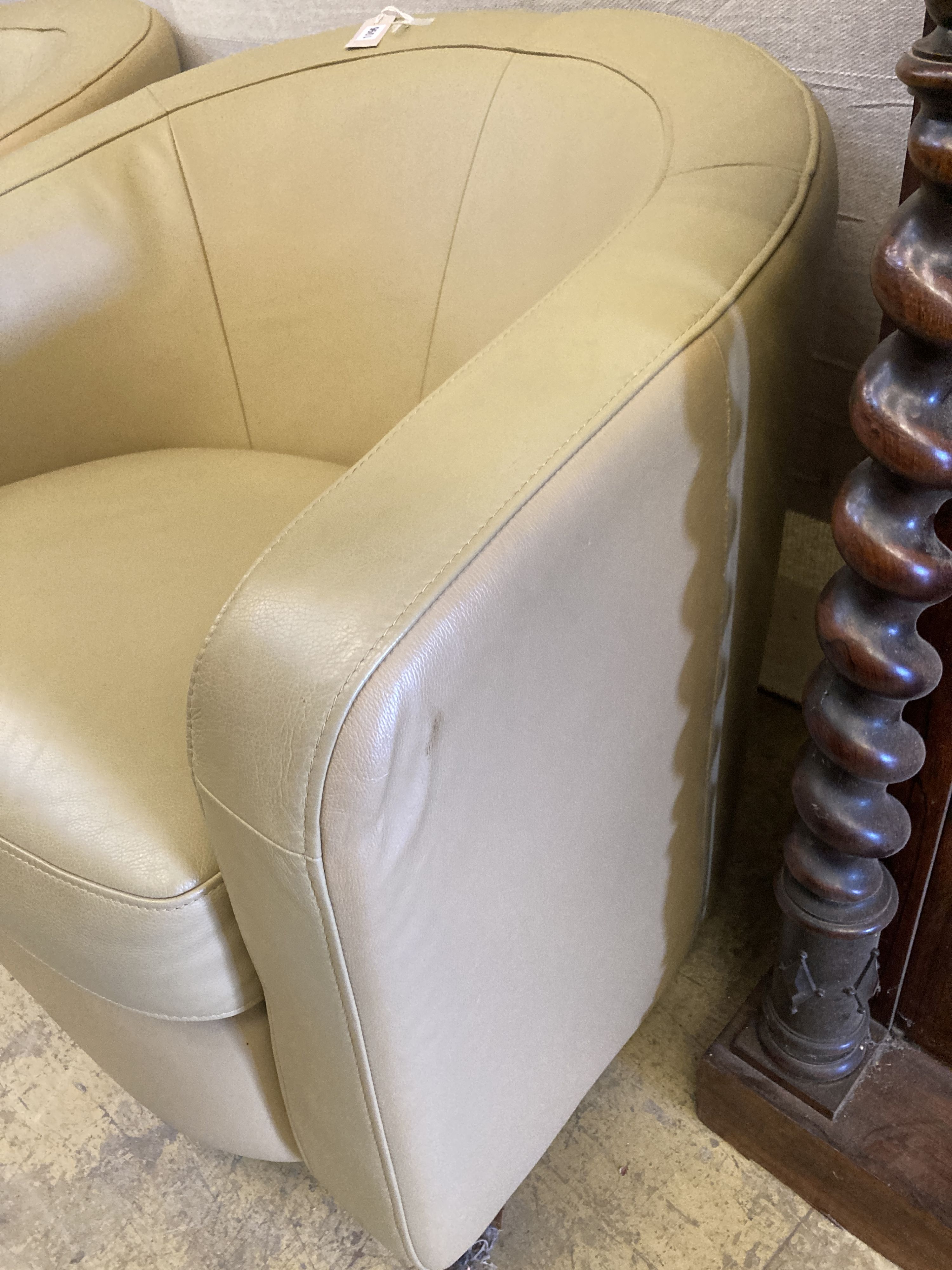 A pair of tub chairs upholstered in cream leather, width 86cm, depth 75cm, height 74cm
